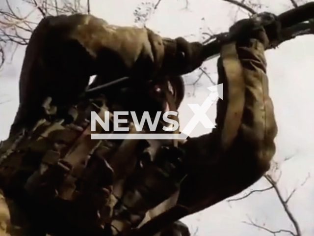 A warrior from territorial defense fires from a machine gun in a battlefield in Ukraine in undated footage.
The footage was released by the Separate brigade of territorial defense of the city of Dnipro on Wednesday, Dec. 21, 2022.
Note: This picture is a screenshot from the video.
(@BrTODnipro/Newsflash)