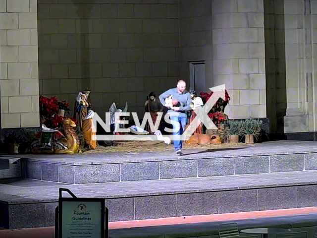 A man steals baby Jesus from the Nativity scene in  Fort Worth, Texas, USA on Saturday, Dec. 17, 2022. Later on the suspect has been identified and baby Jesus was brought back to the Nativity scene. Note: Picture is screenshot from a video. (Fort Worth Police Department/Newsflash)