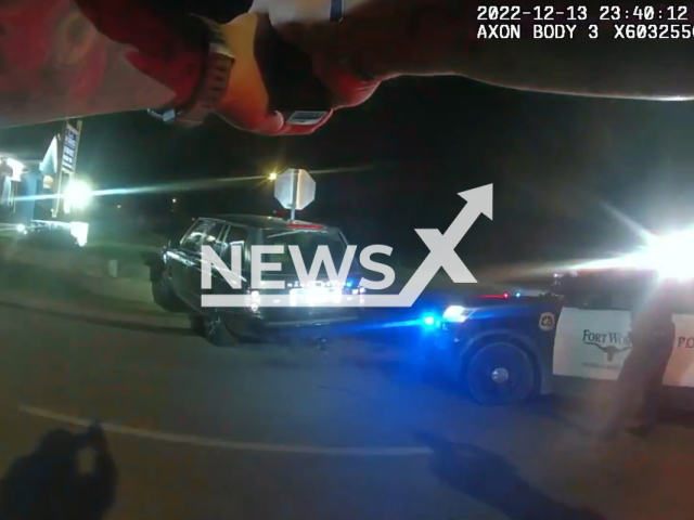 A police officer points a gun at the suspect before the shooting in  Fort Worth, Texas, USA on Tuesday, Dec. 13, 2022. The suspect was shot with a single bullet and was taken to hospital where his condition is described as stable. Note: The picture is a screenshot from the video. (Fort Worth Police Department/Newsflash)