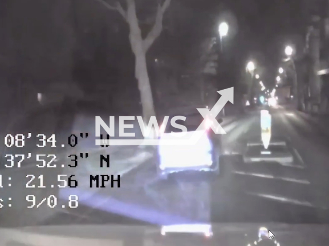 Uninsured driver being pursued by police, driving at speed on the wrong side of the road and the wrong way around a roundabout before the police arrest him at Leicester, England. Note: Picture is a screenshot from a video (Leicestershire Police/Newsflash)