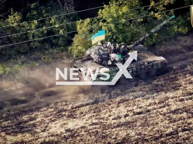 Ukrainian soldiers move on their tank with Ukrainian flag near trees in Ukraine. The footage was obtained from the 22nd Motorized Infantry Battalion of the Ukrainian Ground Forces on Thursday, Dec. 22, 2022.Note: Picture is screenshot from a video. (@22ompb/Newsflash)