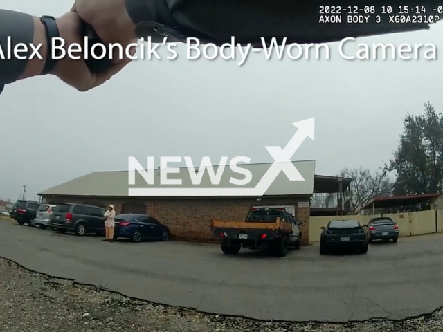 A police officer points a gun at the suspect in Oklahoma City, Oklahoma, USA on Thursday, Dec. 8, 2022. The suspect was wounded and transported to an area hospital where he was treated and released. Note: Picture is a screenshot from a video. (Oklahoma City Police Department/Newsflash)