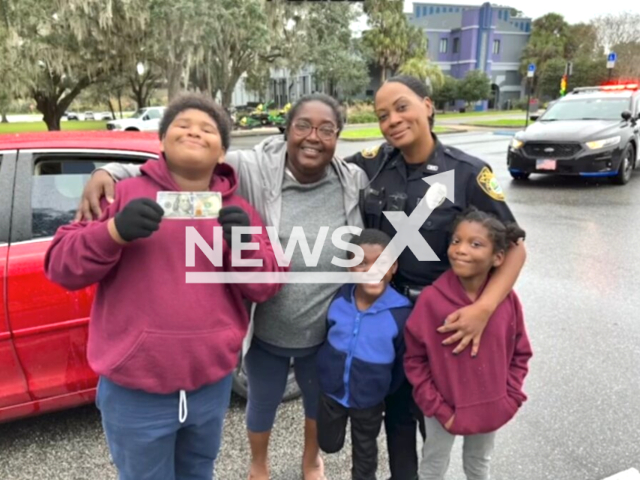 Police officers give money during traffic stops for Christmas in Ocala,  Florida, USA, undated. The money used was donated to OPD anonymously. Note: This picture is a screenshot from the video. (Ocala Police Department/Newsflash)