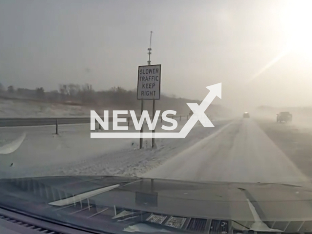 Police patrol vehicle drifts on the road due to strong winds in Wisconsin, USA, on Friday, Dec. 23, 2022. High winds continued into the weekend and led to slippery conditions and reduced visibility. Note: Picture is screenshot from a video. (Wisconsin State Patrol/Newsflash)