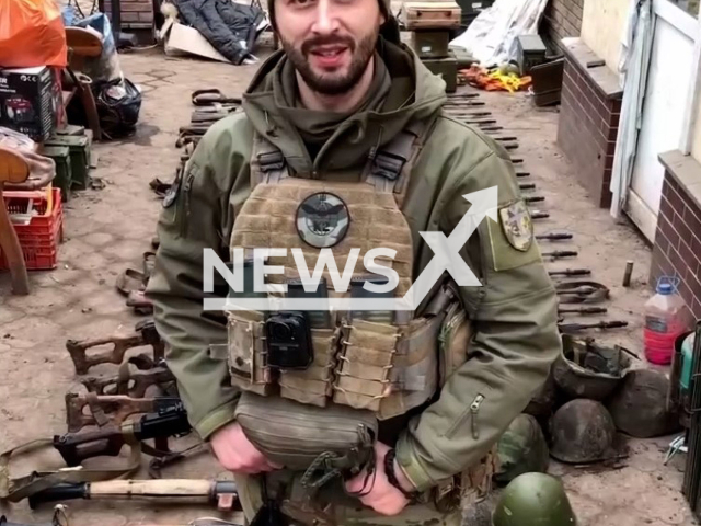 Ukrainian soldier poses in front of captured Russian military ammunition from two last enemy attacks in Ukraine. The footage was obtained from the combat group of the second battalion of the 54th Mechanized Brigade of the Ukrainian Ground Forces on Tuesday, Dec. 27, 2022. Note: Picture is screenshot from a video. (@k_2_54/Newsflash)