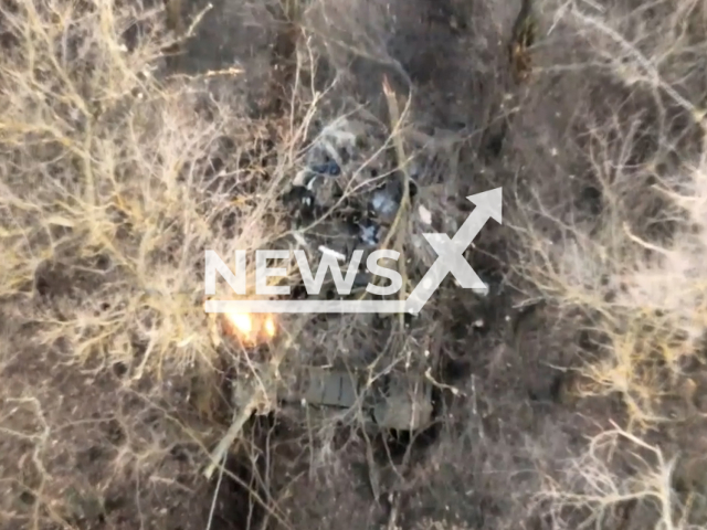 Russian tank burns among trees in Ukraine. The footage was obtained from the 103rd Separate Brigade of Ukrainian Territorial Defense Forces on Tuesday, Dec. 27, 2022.Note: Picture is screenshot from a video. (@oborona.lviv/Newsflash)