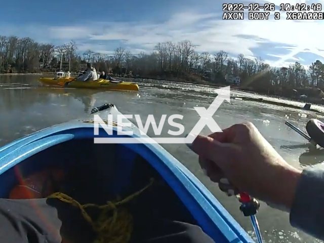 The image shows a police officer in a kayak heading out to rescue an elderly pilot that crashed into an ice covered creek in Maryland, USA on Monday, Dec. 26, 2022. The pilot was identified as Steve Couchman, 71, of Prince Frederick, Maryland. Picture is a screenshot from a video. (AACPD/Newsflash)