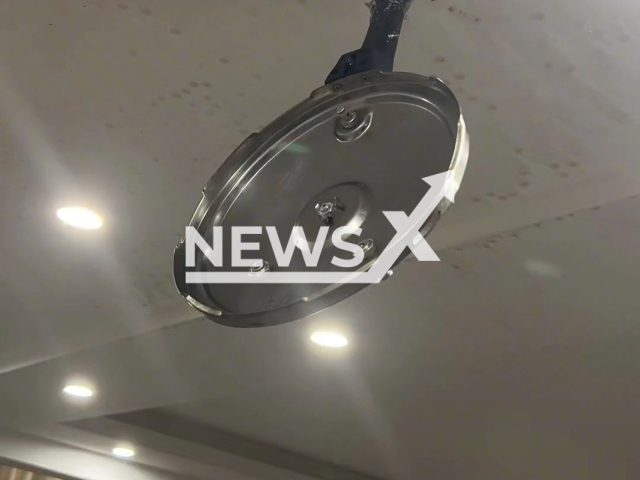 Woman finds pressure cooker lid attached to ceiling in Fushun, Liaoning in China, undated. She heard a loud noise in the kitchen as if something had exploded. Note: Picture is screenshot from a video. (2192253183/AsiaWire)