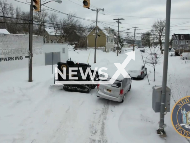 Image shows a police officer using an armoured critical incident vehicle known as the rook to clear streets of abandoned vehicles after record snowfalls in Buffalo, New York, USA, undated. Note: Photo is a screenshoot from video (New York State Police/Newsflash)