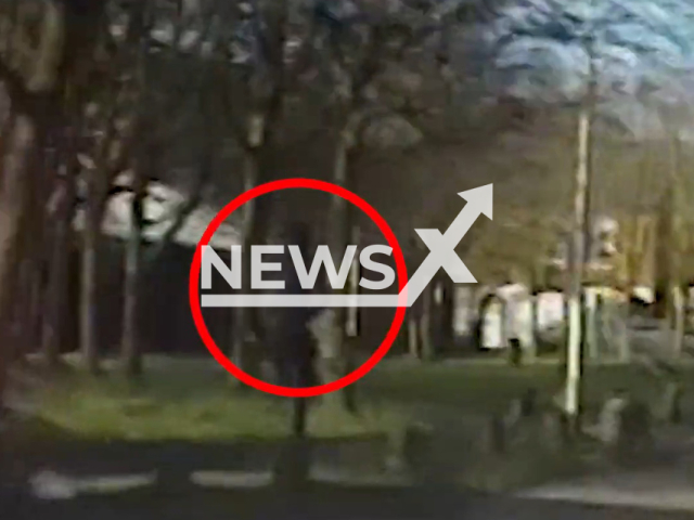 Police officers chase down a gunman on a Birmingham street in West Midlands, England on Monday, Feb. 1, 2021. The suspect was jailed for five years at Birmingham Crown Court on 19 December. Note: This picture is a screenshot from the video. (West Midlands Police/Newsflash)