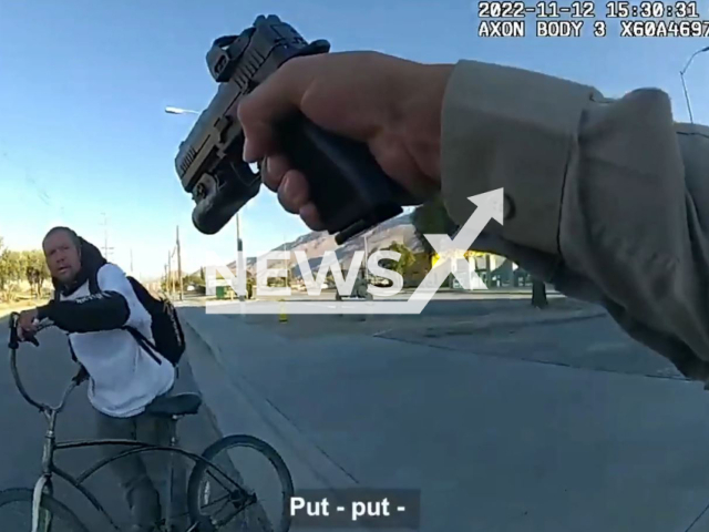 Officer points a gun at the suspect Wallis in Riverside County, California, USA on Saturday, Nov. 12, 2022. Paramedics arrived and pronounced Wallis dead at the scene. Note: Picture is screenshot from a video. (Riverside County Sheriff/Newsflash)