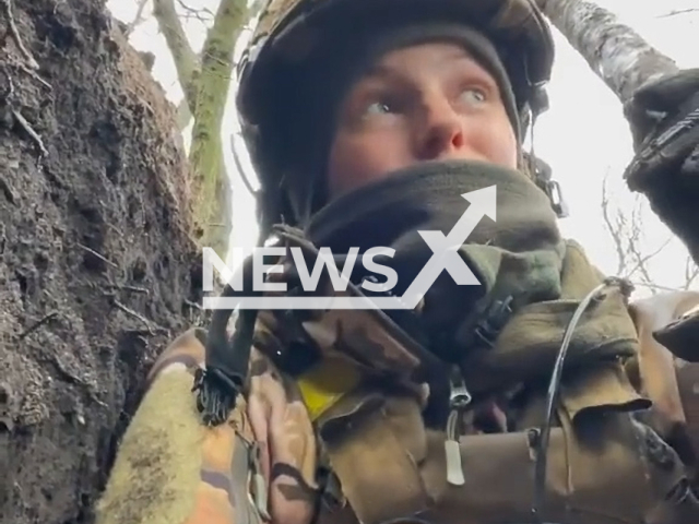 Ukrainian female soldier hides in muddy trench under rain during Russian shelling in Ukraine. The footage was obtained from the Armed Forces of Ukraine on Friday, Dec. 30, 2022. Note: Picture is a screenshot from a video (@AFUkraine/Newsflash)