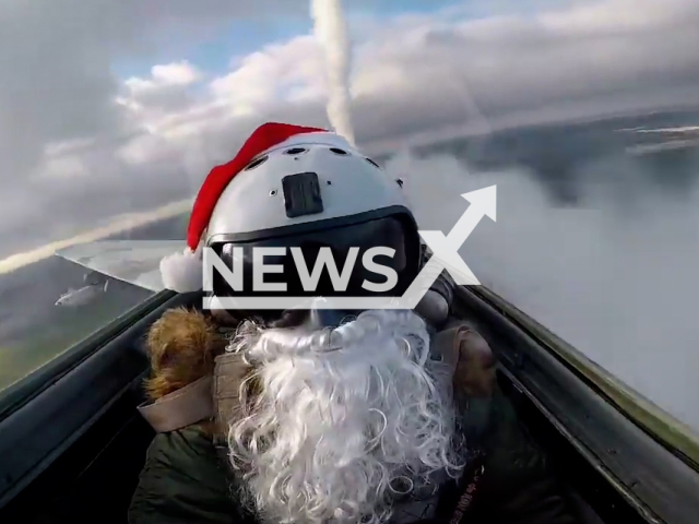 Ukrainian pilot wearing a beard and a Santa hat launches missiles at Russian military positions in Ukraine.
The footage released by the Air Command 'West' of the Air Forces of Ukraine on Saturday, Dec. 31, 2022. Note: This picture is a screenshot from the video. (@kpszsu/Newsflash)