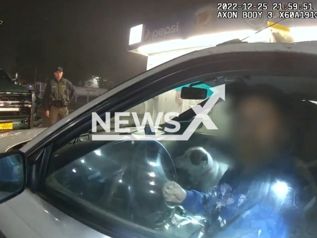 Police officer approaching the suspect  Tomas William Contento, 42  before his arrest on the parking lot in Jackson County, Oregon, USA on Sunday, Dec. 25, 2022. The suspect was lodged in the Jackson County Jail. Note: Picture is a screenshot from the video. (Jackson County Sheriff - Oregon/Newsflash)