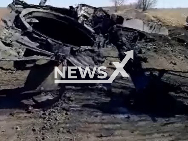 Picture shows remains of destroyed Russian battle tank in a field area in Ukraine. The footage was obtained from the Ukrainian Ground Forces on Sunday, Jan. 1, 2023. Note: This picture is a screenshot from the video. (@UkrainianLandForces/Newsflash)