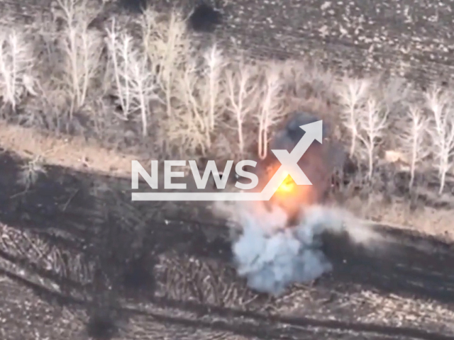 Picture shows an explosion at Russian troops' position among trees in Ukraine. The footage was obtained from the 66th brigade of the Ukrainian Ground Forces on Sunday, Jan. 1, 2023. Note: Picture is a screenshot from a video (@66ombr/Newsflash)