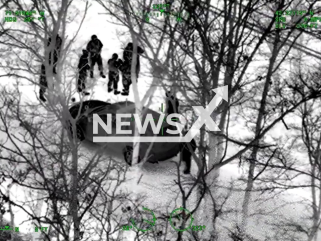 This footage shows police tracking down a robber hiding in a tree with the help of air support in Massachusetts, USA, undated. State Police will summons the suspect for additional motor vehicle charges related to the pursuit. Note: This picture is a screenshot from the video. (Mass State Police/Newsflash)