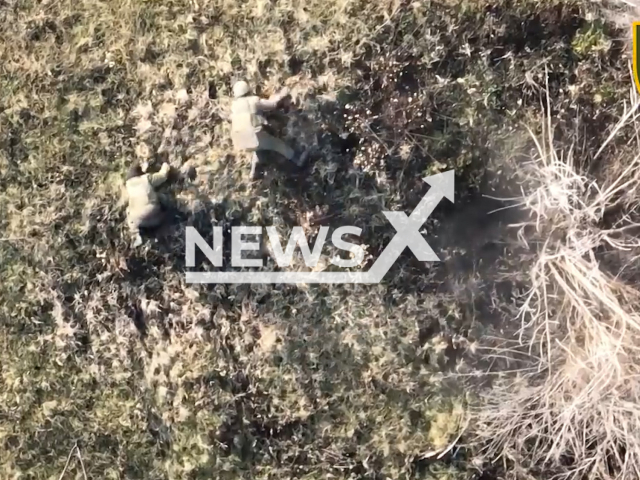 Russian soldiers roll on the field after being bombed by the Ukrainian fighters in Ukraine in undated footage. The footage released by the 28th separate mechanized brigade on Tuesday, Jan. 3, 2022. Note: This picture is a screenshot from the video. (@28brigade/Newsflash)