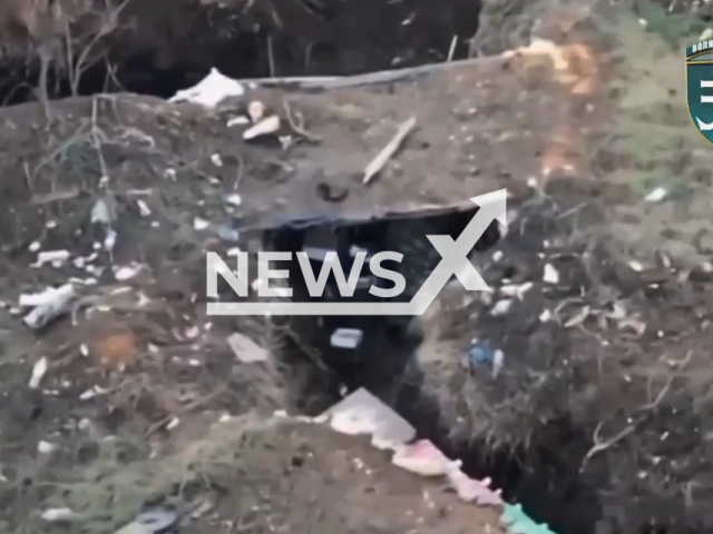 Russian osoldier hides in dugout in a field area in Ukraine in undated footage. The footage was obtained from the 35th brigade of the Ukrainian Navy on Thursday, Jan. 5, 2023. Note: Picture is a screenshot from a video (@35obrmp/Newsflash)