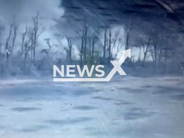 Picture shows an explosion among trees in Ukraine in undated footage. The footage was obtained from the 66th brigade of the Ukrainian Ground Forces on Wednesday, Jan. 4, 2023. Note: Picture is a screenshot from a video (@66ombr/Newsflash)