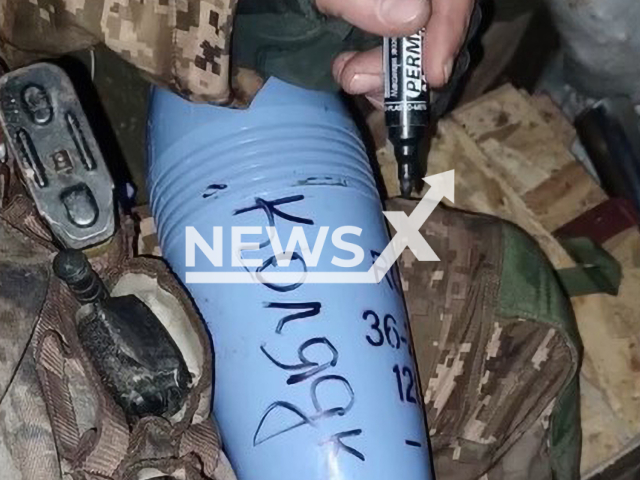 Ukrainian soldier writes the word "Carol" on the rocket for Russian occupiers in Ukraine in undated footage. The footage was released by the Zaporizhzhia separate territorial defense brigade on Sunday, Jan. 8, 2023.Note: Picture is screenshot from a video (@110tro/Newsflash).