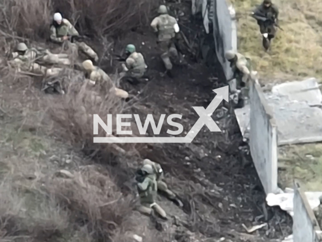 Picture shows a group of Russian soldiers in a residential area of Soledar, Donetsk region, Ukraine in January, 2023. Russian troops were attacked by fire from large-caliber machine guns. Note: Picture is screenshot from a video. (@dpsu.gov.ua/Newsflash)