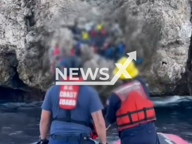 US Coast Guard Cutter Joseph Napier  staff talk to Haitians  on Monito Island, Puerto Rico, USA, on Sunday, Jan. 8, 2022. 
They rescued  19 Haitians left stranded by smugglers. Note: Picture is screenshot from a video. (U.S. Coast Guard District 7/Newsflash)