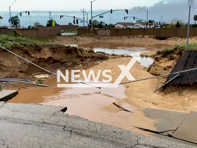 This picture shows a major sinkhole that opened up after a violent storm caused major flooding as water came pouring down the streets of Orcutt, California, USA, undated. The town suffered great immense to its infrastructure, and 15 people had to be evacuated from their homes. Note: Picture is screenshot from a video. (@SBCFireInfo/Newsflash)