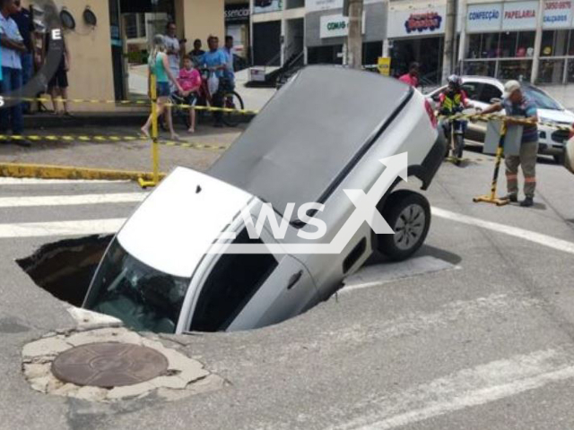 Picture shows a truck fallen into a sinkhole that opened on the road in Joao Monlevade, Brazil, this Monday, Jan. 9, 2023. Rains of in the previous few days  were the cause of the sinkhole, and   a 24-year-old driver was left with  minor injuries.   
Note: Private photo.  (Defesa Civil/Newsflash)