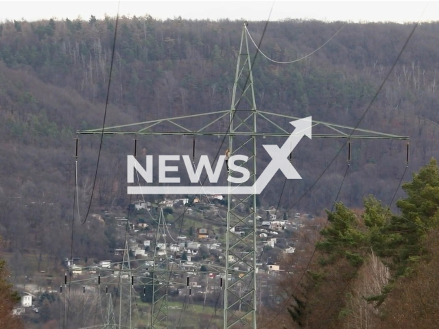 Image shows the woman climbing the transmission tower, undated photo. The peculiar case happened at around 10.50am in the town of Freital, in Saxony, Germany, on Wednesday, Jan. 11, 2023. Note: Photo is a screenshot from a video. (Newsflash)