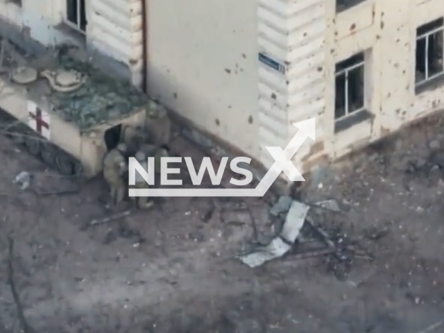 Ukrainian military medics load wounded soldier into their military vehicle in a damaged residential area in Soledar, Donetsk region, Ukraine in undated footage. The footage was released by the AFU StratCom on Wednesday, Jan. 11, 2023. Note: Picture is a screenshot from a video. (@AFUStratCom/Newsflash)