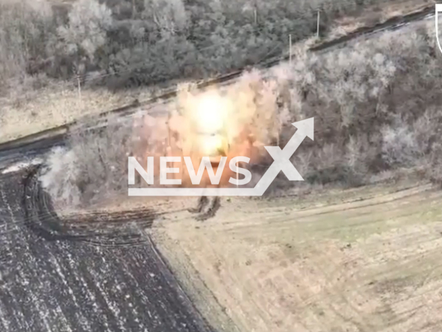 Russian tank explodes among trees in Ukraine in undated footage. The footage was released by the 103rd brigade of the Ukrainian Territorial Defense Forces on Wednesday, Jan. 11, 2023. Note: Picture is a screenshot from a video. (@oborona.lviv/Newsflash)