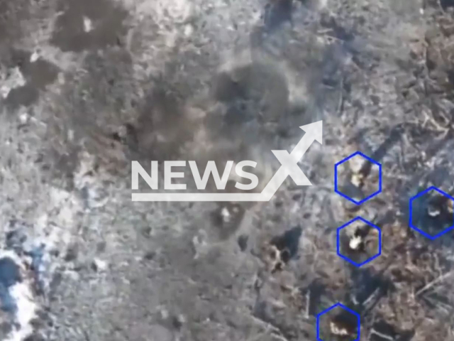 Picture shows an explosion near Ukrainian soldiers moving among trees in a snowy field in Ukraine in undated footage. The footage was obtained from the People's Militia of the DPR on Thursday, Jan. 12, 2023.  Note: Picture is a screenshot from a video. (@nm_dnr/Newsflash)