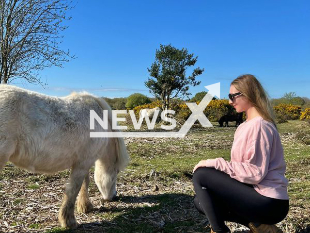 Linda Prigarska poses with a white horse in New Forest National Park, England, in an undated photo. According to Linda, her love for nature and wildlife has been ingrained into her since her early childhood. Note: We obtained permission for this photo. (@lemon.rise/Newsflash)