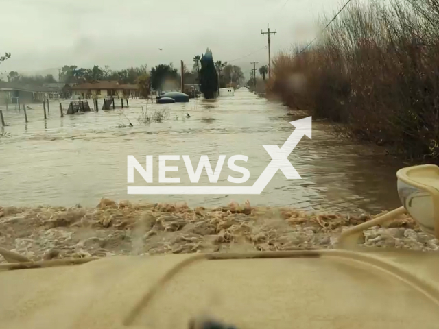 Crews from the Sheriff's Office of San Benito County drive through flooded water in a proper tactical vehicle in San Benito County, California, USA, on Monday, Jan. 9, 2023. The San Benito County Search and Rescue advised residents against trying to drive through the flood themselves. Note: Picture is a screenshot from a video.  (San Benito County Search & Rescue/Newsflash)