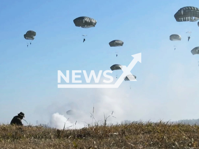 This picture shows members from Yokota's 36th Airlift Squadron and the Japan Ground Self-Defence Force executing training jumps over a drop zone in Japan on Sunday, Dec. 8, 2023. Members from the US airlift squadron and the Japanese forces teamed up in training on 8th January to enhance the US/Japan alliance. 
 Note: Photo is a screenshot from a video. (DVIDS/Newsflash)