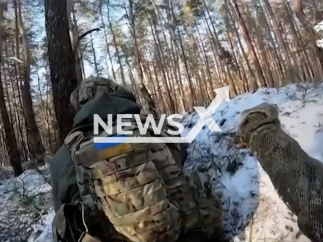 Picture shows Ukrainian soldiers with guns among trees in snow near Kreminna, Luhansk Oblast, Ukraine in undated footage. The footage was released by the Command of the Ukrainian Special Operations Forces on Monday, Jan. 16, 2023. Note: Picture is screenshot from a video.(@usofcom/Newsflash)