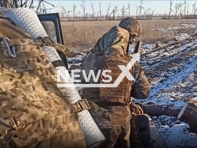 Ukrainian soldiers come to change their colleagues at the frontline in a snowy field in Ukraine in undated footage. The footage was released by the separate brigade of territorial defense of the city of Dnipro on Monday, Jan. 16, 2023.  Note: Picture is screenshot from a video. (@BrTODnipro/Newsflash)