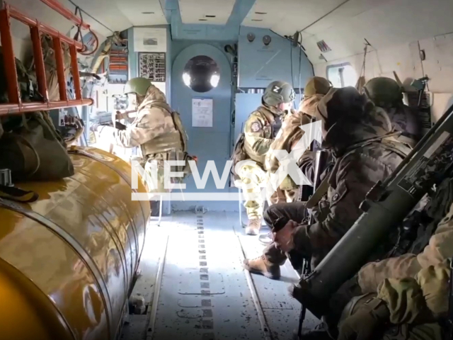 Picture shows Russian soldiers with military ammunition inside of attack helicopter in Ukraine in undated footage. The footage was released by the Russian Ministry of Defence on Tuesday, Jan. 17, 2023.Note: Picture is screenshot from a video. (@mod_russia/Newsflash)