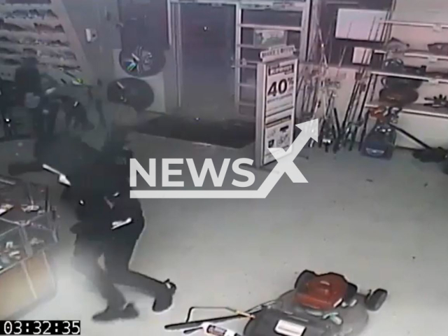 Suspects break into a pawn shop using a saw, in Sanford, Florida, on Tuesday, Dec. 13, 2022. The burglars stole electronics and jewelry from the shop. Note: Picture is screenshot from a video. (Sanford Police Department/Newsflash)