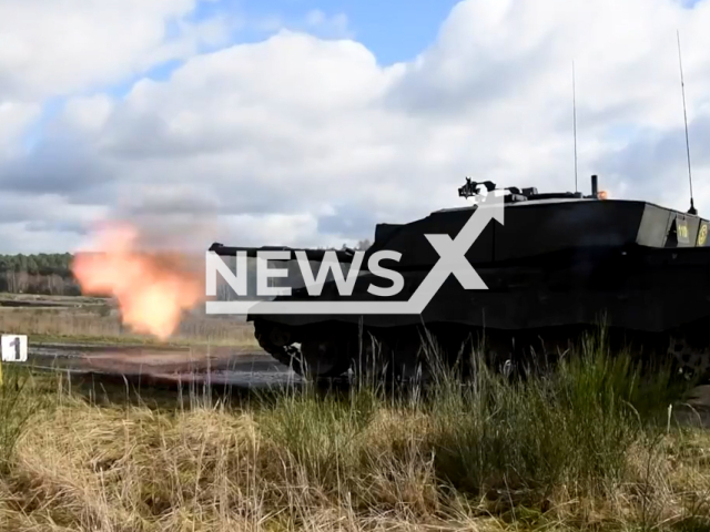 The UK Challenger 2 tank shoots at its targets in a field area in undated footage. The UK will send a squadron of Challenger 2 tanks to Ukraine. Note: Photo is a screenshot from a video. (@defencehq/Newsflash)