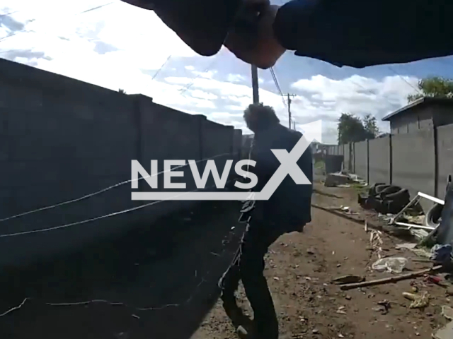 Phoenix police officer shoots suspect holding scissors, in Phoenix, Arizona, on Tuesday, Jan. 3, 2023. The suspect was taken to the hospital where he later died from his injuries.  Note: This picture is a screenshot from the video. (PhoenixPolice/Newsflash)