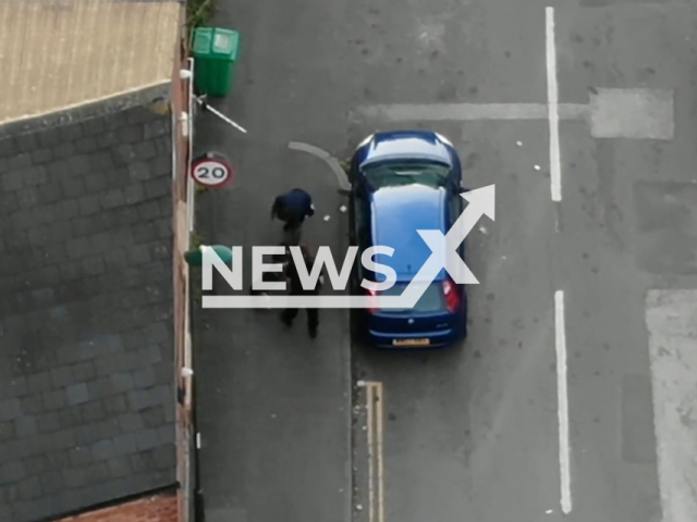 Description: Drug dealer, Leon Smart, 36, climbes through a bathroom window and attempts to evade the police, in Old Basford, Nottingham, on Sept. 21, 2021. The suspect was arrested and eventually sentenced to nine years in prison. Notes: Picture is screen from a video.(Nottinghamshire Police/Newsflash)