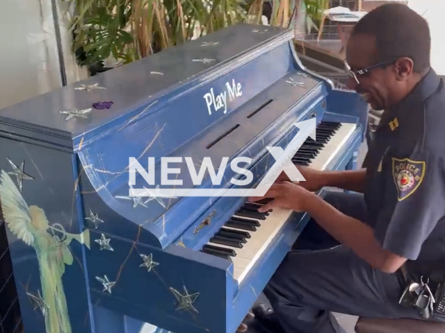 Captain Prurince Dice plays the community piano in downtown DeLand, Florida, in undated footage. Captain Dice has more than 16 years of law enforcement experience. Note: Photo is screenshot from a video. (@DeLandPD/Newsflash)