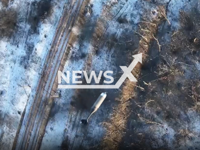 Bomb falls on Russian soldiers in a field area in Ukraine in undated footage. The footage was released by the Adam Joint Tactical Group on Wednesday, Jan. 18, 2022. Note: Photo is screenshot from a video. (@adamtactic/Newsflash)