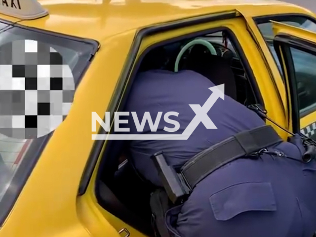 Police officer provides aid to a taxi passenger in labor, in Panama City, Panama, in undated footage. A courageous taxi driver had taken the passenger to the Citizen Attention room of the Nuevo Tocumen Substation. Note: Photo is screenshot from a video. (Policia Nacional de Panama/Newsflash)