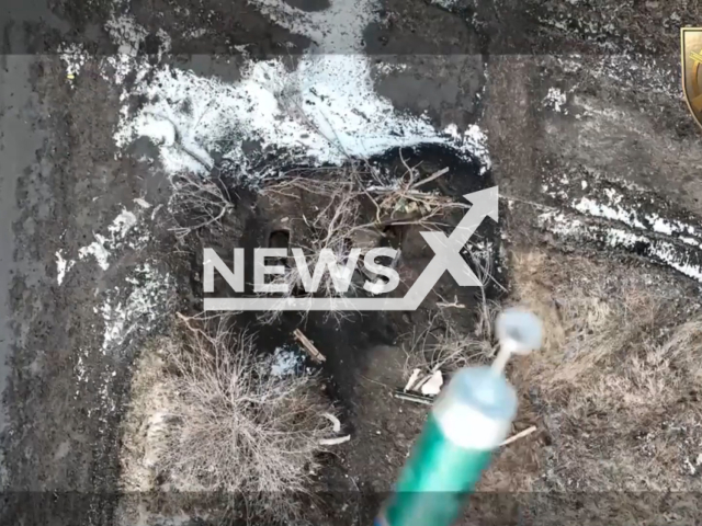 Bomb falls on Russian troops hiding in a snowy foxhole in Ukraine in undated footage. The footage was released by the 22nd battalion of the Ukrainian Ground Forces on Thursday, Jan. 19, 2023.Note: Picture is screenshot from a video. (@22ompb/Newsflash)