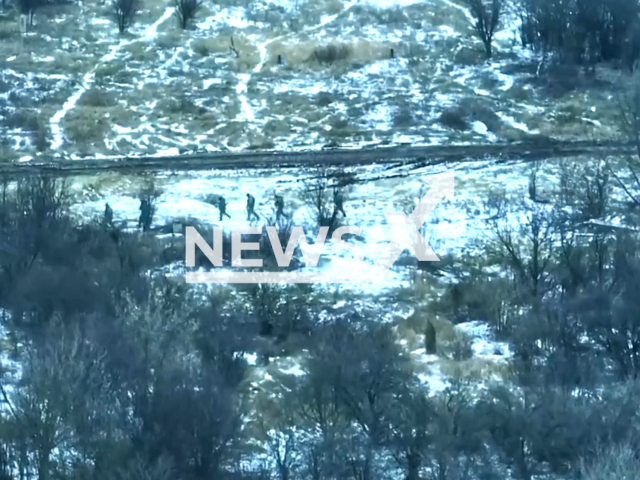 Russian occupiers move near trees in the snow in Ukraine in undated footage. The footage was relayed by Serhiy Bratchuk, spokesman for the Odesa Military Administration on Thursday, Jan. 19, 2023. Note: Picture is screenshot from a video. (Seneka93 unit/Newsflash)