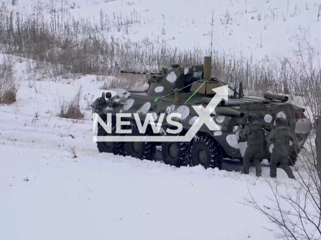 Russian servicemen of the engineering sapper regiment move in the snow after military vehicle during combat exercises in Leningrad Oblast, Russia in undated footage. The footage was released by the Russian Ministry of Defence on Friday, Jan. 20, 2023.  Note: Picture is screenshot from a video. (@mil.ru/Newsflash)