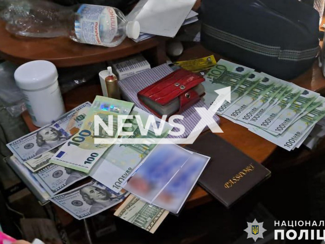 Picture shows the money and documents found by police, undated. Police arrested suspects running a business helping men of conscription age cross the border of Ukraine, by forging documents for departure for EUR 6000, in Mykolaiv, Ukraine.  
Note: Police photo. (@UA.National.Police.Nikolaev/Newsflash)